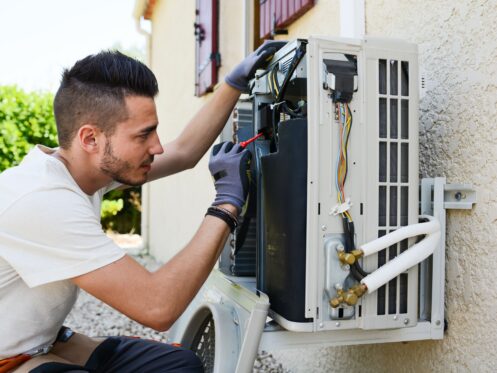 Technician providing HVAC services in a home in Denver.